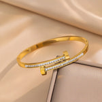 Waterproof gold bypass bangle with baguette crystals Biya Accessoires UAE.