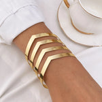 Non-tarnish geometric V-shape gold statement bangle for women Dubai luxury fashion.