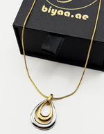 18K gold and silver two-tone teardrop pendant necklace.