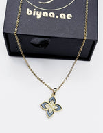 18K gold plated black quatrefoil clover pendant necklace by Biya Accessoires.