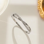 silver plated Roman numeral and crystal crossover bangle by Biya Accessoires.