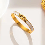 18K gold plated pearlescent enamel mariner link bangle by Biya Accessoires.