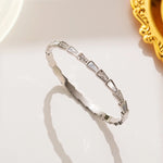 silver plated serpentine geometric segmented bangle by Biya Accessoires.