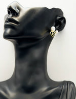Close-up of premium hypoallergenic imitation jewelry featuring a dual band pearl stud.