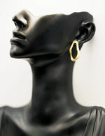 Biya Accessoires matte gold abstract sculptural stud earrings.