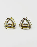 Close up of imitation jewelry uae statement studs featuring iridescent stones and pavé.