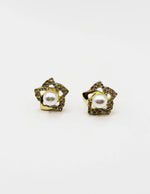 Biya Accessoires gold swirl stud earrings with pearl and crystals.