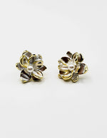 Biya Accessoires gold trim pearlescent flower stud earrings.