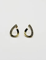Biya Accessoires gold twisted teardrop hoop earrings with crystals.