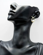 Close-up of hypoallergenic imitation jewelry featuring a pearl and pavé design.