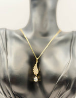 Biya Accessoires 18K gold plated angel wing necklace with pave crystals and teardrop stone.