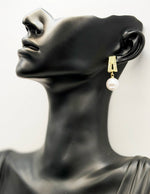 Close-up of premium hypoallergenic imitation jewelry featuring a large white pearl drop.