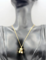 Biya Accessoires 18K gold plated peanut shell necklace with twin pearls and pave crystals.
