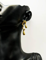 Biya Accessoires 18K gold plated asymmetrical molten drop earrings.