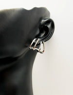 Close-up of premium hypoallergenic imitation jewelry featuring geometric claw design.