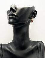 Close up of premium hypoallergenic imitation jewelry featuring a smooth brown sweep design.