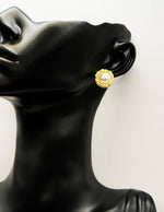 Close-up of premium hypoallergenic imitation jewelry featuring a braided gold frame.