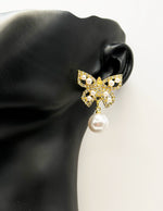 Best imitation jewellery brands in uae gold butterfly studs with large pearl drops.