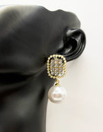 Best imitation jewellery brands in uae gold earrings with rhinestone center and pearl border.