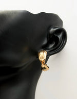 Everyday luxury fashion jewelry gold tone twisted hoops by Biya Accessoires Dubai.