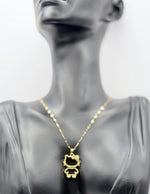 Waterproof gold feline bow necklace with cubic zirconia on silk.