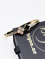 Waterproof gold dual quatrefoil channel set crystal bracelet for women Dubai.