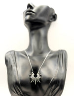 Waterproof silver sunburst spike pendant necklace in green gift box by Biya Accessoires.