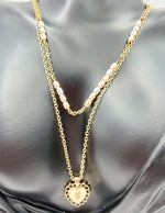 Waterproof and non-tarnish artificial gold layered jewelry resting on silk fabric.