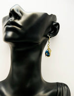Best imitation jewellery brands in uae gold peacock earrings with deep blue teardrop stones.