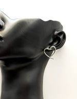 Everyday luxury fashion jewelry silver tone heart studs by Biya Accessoires Dubai.