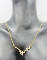 Modern luxury gold asymmetrical V-necklace for evening wear UAE.