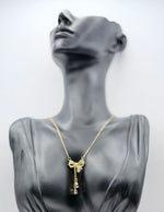 18K gold plated crystal bow lariat necklace by Biya Accessoires.