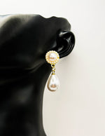Close up of elegant imitation jewelry uae featuring a pearl stud halo and teardrop dangle.