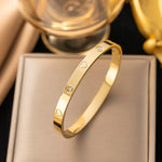 18K gold plated engraved heart and flush crystal bangle by Biya Accessoires.