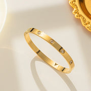 18K gold plated flush crystal flat band bangle by Biya Accessoires.