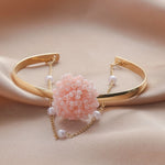 Hypoallergenic gold plated open bracelet with pink beaded centerpiece United Arab Emirates.