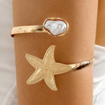 Waterproof 18K gold upper arm cuff with starfish and baroque pearl Biya Accessoires UAE.