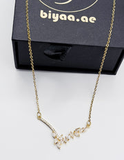 18K gold plated Seraphina asymmetrical crystal wing necklace by Biya Accessoires.