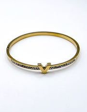 Gold bracelet with small stones on a white background