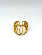Gold ring with a modern design on a white background