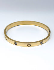 18K gold plated engraved clover and flush crystal bangle by Biya Accessoires.