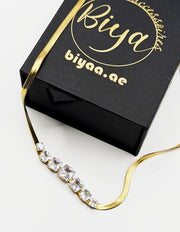 Modern luxury gold liquid chain and princess cut stone necklace UAE.