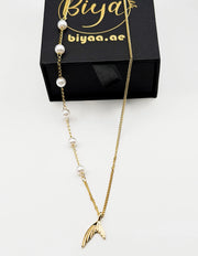 18K gold plated mermaid tail and pearl necklace by Biya Accessoires.