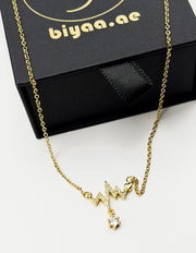 Waterproof gold EKG pulse pendant with crystal drop on silk Dubai.