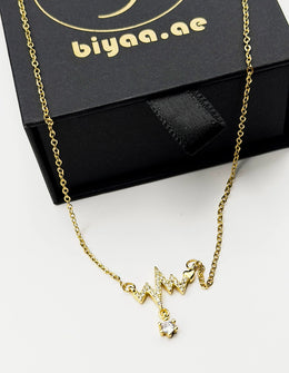 Waterproof gold EKG pulse pendant with crystal drop on silk Dubai.