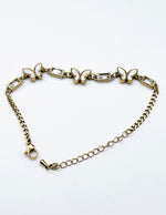 Modern luxury fine art editorial jewelry delicate gold butterfly chain bracelet gift for her.