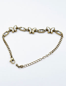 Modern luxury fine art editorial jewelry delicate gold butterfly chain bracelet gift for her.