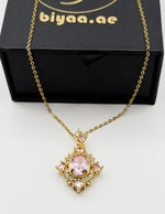 Waterproof gold royal pink gemstone style necklace on silk.