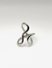 Silver ring with a twisted design on a light gray background