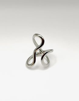 Silver ring with a twisted design on a light gray background